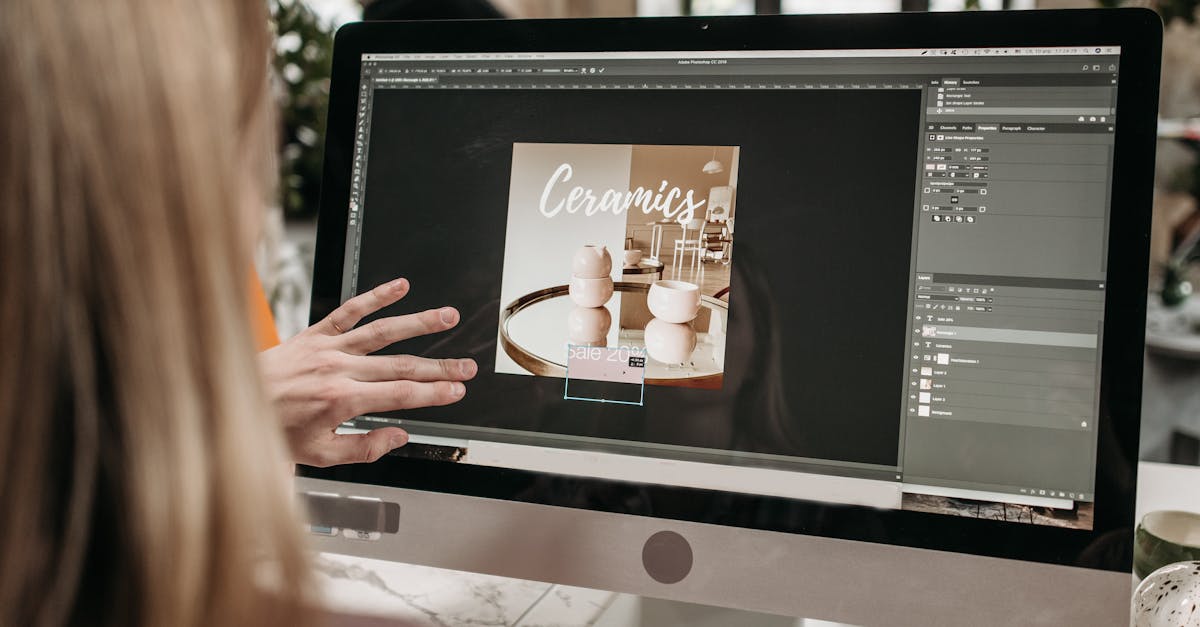 A graphic designer works on a ceramics promotion using Adobe Photoshop on an iMac.